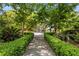 Well manicured backyard garden with a stone pathway leading to a fountain at 2970 Roseville Rd, Wadmalaw Island, SC 29487
