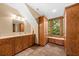 Well-lit bathroom featuring a vanity with storage and a scenic view of the surrounding trees at 2970 Roseville Rd, Wadmalaw Island, SC 29487