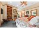 Inviting bedroom with a fireplace, built-in shelving, and a king bed at 2970 Roseville Rd, Wadmalaw Island, SC 29487