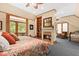 Cozy bedroom suite featuring a fireplace, built-in bookshelves, and sitting area at 2970 Roseville Rd, Wadmalaw Island, SC 29487