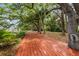 Scenic boardwalk lined with mature trees, providing a serene pathway with beautiful views of the natural surroundings at 2970 Roseville Rd, Wadmalaw Island, SC 29487