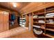 Rustic closet with solid wood construction features ample shelving and hanging space at 2970 Roseville Rd, Wadmalaw Island, SC 29487
