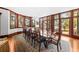 A formal dining room features large windows, a chandelier, a long table, and elegant accents and access to the outdoors at 2970 Roseville Rd, Wadmalaw Island, SC 29487