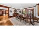A formal dining room features large windows, a chandelier, a long table, and elegant accents and traditional decor at 2970 Roseville Rd, Wadmalaw Island, SC 29487