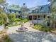 Grand residence featuring manicured landscaping, a striking circular tower, and a paver driveway at 2970 Roseville Rd, Wadmalaw Island, SC 29487