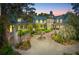 Stately home featuring a circular driveway, elegant fountain, and lush landscaping at 2970 Roseville Rd, Wadmalaw Island, SC 29487