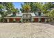 Sprawling home with a three-car garage and expansive driveway, enhanced by a palm tree at 2970 Roseville Rd, Wadmalaw Island, SC 29487