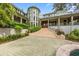Imposing residence with mature landscaping, multiple windows, a prominent entryway, and a paver driveway at 2970 Roseville Rd, Wadmalaw Island, SC 29487