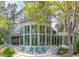Beautiful home featuring many windows, porch and patio areas, and a lush yard with trees at 2970 Roseville Rd, Wadmalaw Island, SC 29487