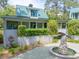 Elegant exterior showcasing professional landscaping, a fountain, and a bridge walkway at 2970 Roseville Rd, Wadmalaw Island, SC 29487