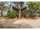 Inviting home with a brick driveway, mature trees, and a well-maintained lawn at 2970 Roseville Rd, Wadmalaw Island, SC 29487