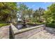 Beautiful courtyard features a stunning three-tier fountain surrounded by lush landscaping and manicured gardens at 2970 Roseville Rd, Wadmalaw Island, SC 29487