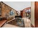 Grand foyer featuring stone accents, spiral staircase, piano, and beautiful rug with seating area and abundant natural light at 2970 Roseville Rd, Wadmalaw Island, SC 29487