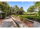 Serene backyard garden showcasing hedges and greenery in a formal design at 2970 Roseville Rd, Wadmalaw Island, SC 29487