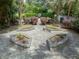 Tranquil garden featuring symmetrical flower beds, stone pathways, and verdant landscaping, perfect for relaxation at 2970 Roseville Rd, Wadmalaw Island, SC 29487