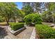 Picturesque garden featuring a shaded arbor, manicured hedges, stone pathways, and verdant landscaping at 2970 Roseville Rd, Wadmalaw Island, SC 29487