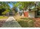 Exterior shot shows a greenhouse with a brick walkway, showcasing an inviting exterior at 2970 Roseville Rd, Wadmalaw Island, SC 29487