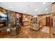 Well-appointed kitchen with stone accents, an island, stainless appliances, and hardwood floors at 2970 Roseville Rd, Wadmalaw Island, SC 29487