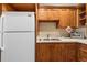Kitchen features a stainless steel sink, plenty of cabinetry, and a white refrigerator at 2970 Roseville Rd, Wadmalaw Island, SC 29487