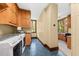 A bright laundry room includes built in storage, workspace and modern washer and dryer units and adjacent to the office area at 2970 Roseville Rd, Wadmalaw Island, SC 29487