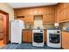 Convenient laundry room with modern appliances, ample cabinet space, utility sink, and new washer and dryer units at 2970 Roseville Rd, Wadmalaw Island, SC 29487
