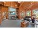Comfortable living room features stone fireplace, built-in shelves, and natural light at 2970 Roseville Rd, Wadmalaw Island, SC 29487