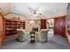 Cozy living room with a fireplace, built-in bookcase, and comfortable seating at 2970 Roseville Rd, Wadmalaw Island, SC 29487