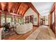 Open living area boasting a vaulted wood ceiling, built-in shelving, and rich wood floors at 2970 Roseville Rd, Wadmalaw Island, SC 29487