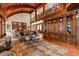 Open living room with wood floors, custom built-ins, and comfortable seating at 2970 Roseville Rd, Wadmalaw Island, SC 29487