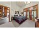 Serene primary bedroom with large windows and stylish furnishings at 2970 Roseville Rd, Wadmalaw Island, SC 29487