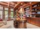 An elegant home office with wood paneled walls, coffered ceilings, built-in bookshelves, and traditional furniture at 2970 Roseville Rd, Wadmalaw Island, SC 29487