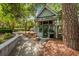 Charming outdoor kitchen with stainless steel grill, adjacent to a stone walkway and lush landscaping at 2970 Roseville Rd, Wadmalaw Island, SC 29487