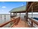 Beautiful pier with an outdoor kitchen, sink, seating, and boat slip on the water at 2970 Roseville Rd, Wadmalaw Island, SC 29487