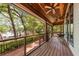 Inviting porch featuring wood floors, ceiling fans, and a beautiful view of the surrounding trees at 2970 Roseville Rd, Wadmalaw Island, SC 29487