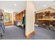 Spacious walk-in closet with custom wood shelving and bench with window view at 2970 Roseville Rd, Wadmalaw Island, SC 29487
