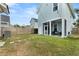 Well-maintained backyard with a screened-in porch, lush green grass, and a wooden fence at 308 Watergrass St, Summerville, SC 29486