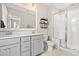 Modern bathroom featuring double sinks, a glass-enclosed shower with tile surround, and neutral decor at 308 Watergrass St, Summerville, SC 29486