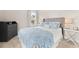 Cozy bedroom showcases a comfortable bed with a patterned blue duvet cover and gray headboard at 308 Watergrass St, Summerville, SC 29486