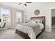Spacious bedroom with a large bed, two windows providing natural light, and a walk-in closet at 308 Watergrass St, Summerville, SC 29486