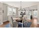 Bright dining area with a wooden table and chairs, flowing into an open kitchen concept at 308 Watergrass St, Summerville, SC 29486