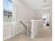 Upstairs hallway with natural light and carpet flooring leads to bedrooms and other living areas at 308 Watergrass St, Summerville, SC 29486