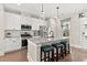 Modern kitchen features white cabinets, granite countertops, stainless steel appliances, and barstool seating at 308 Watergrass St, Summerville, SC 29486