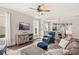 Comfortable living room features a ceiling fan, a plush couch, and an entertainment center at 308 Watergrass St, Summerville, SC 29486