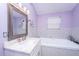 This updated bathroom features a large mirror, vanity sink, and a soaking tub at 312 Lake Moultrie Dr, Bonneau, SC 29431