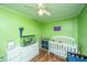 bedroom with green walls, white furniture, and playful decor at 312 Lake Moultrie Dr, Bonneau, SC 29431