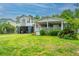 Charming two-story home featuring a large yard, an open carport, and a cozy porch in a picturesque neighborhood at 312 Lake Moultrie Dr, Bonneau, SC 29431