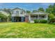Charming two-story home with a well-maintained lawn and a covered front porch perfect for relaxing at 312 Lake Moultrie Dr, Bonneau, SC 29431