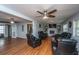 Spacious living room with hardwood floors, a brick fireplace, and comfortable leather seating offering a cozy ambiance at 312 Lake Moultrie Dr, Bonneau, SC 29431