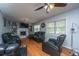 Cozy living room with hardwood floors, a brick fireplace, comfortable seating, and plenty of natural light at 312 Lake Moultrie Dr, Bonneau, SC 29431