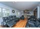 Spacious living room with hardwood floors, comfortable leather seating, and natural light from the large windows at 312 Lake Moultrie Dr, Bonneau, SC 29431